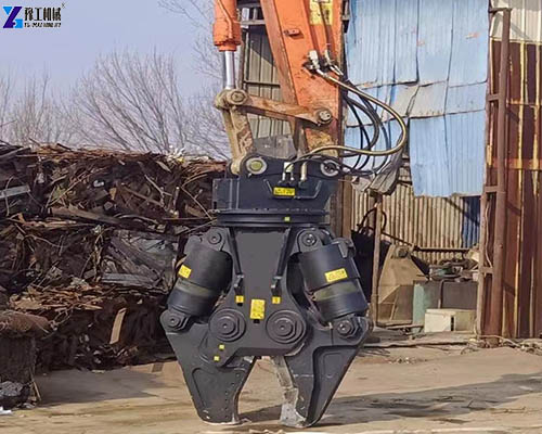 rotating double cylinder shear working at scrapyard